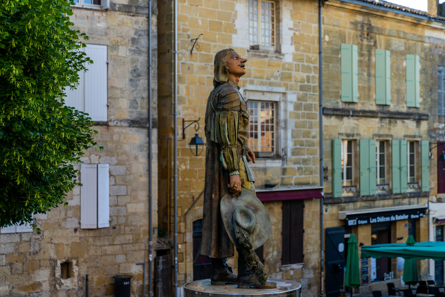 the statue of Cyrano de Bergerac in the historic city center